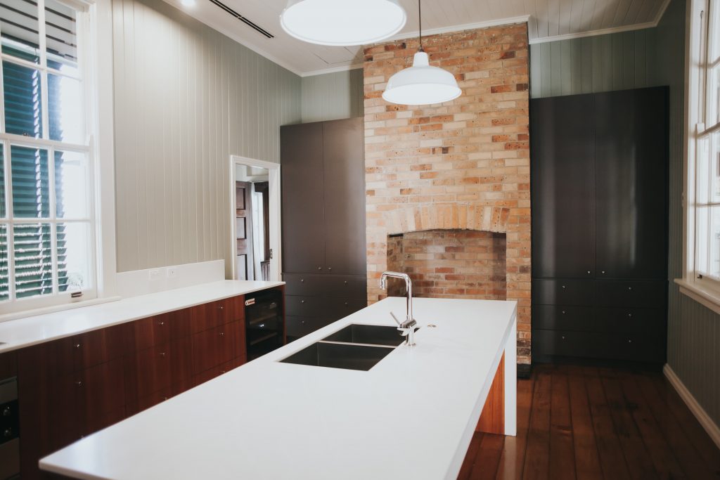 kitchen island with red brick wall in the background